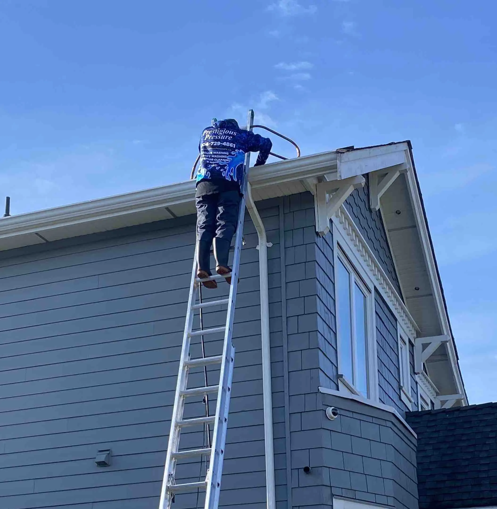 Clearing and flushing a downspout on a home in Burnaby, BC