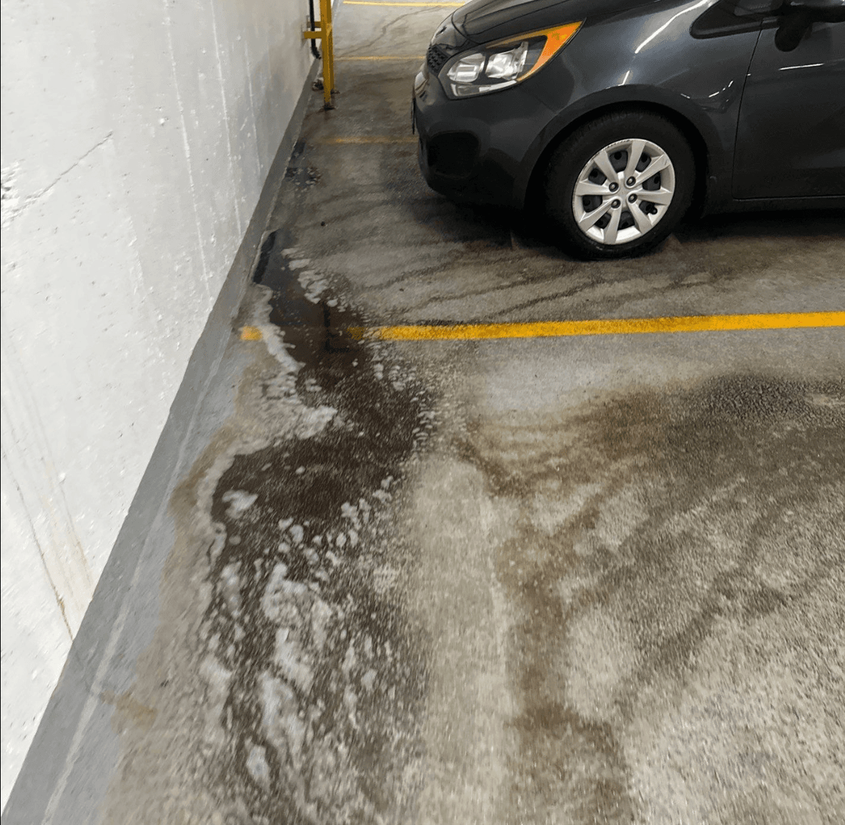 hazard cleaning - oil spill picture in parkade in Burnaby